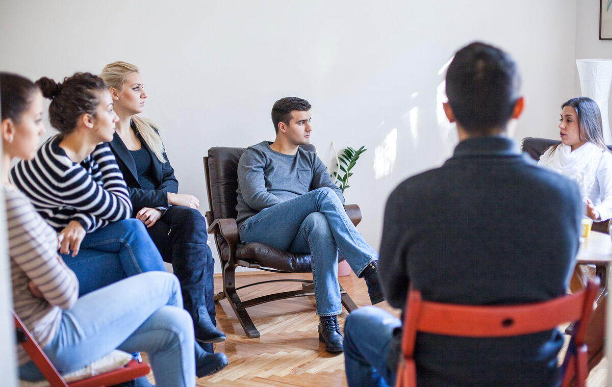 People sitting in group therapy session