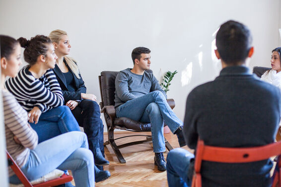 People sitting in group therapy session