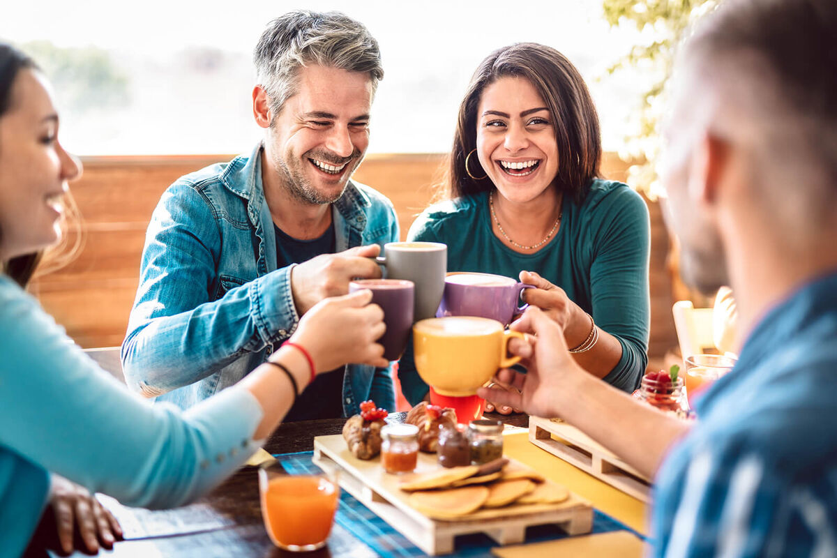 People group toasting latte at coffee bar rooftop