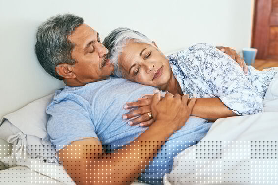 senior couple embracing in bed