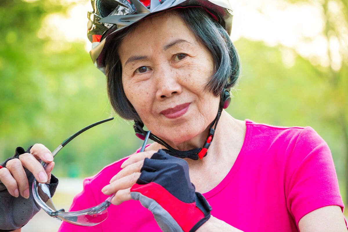 Senior woman wearing bike gloves
