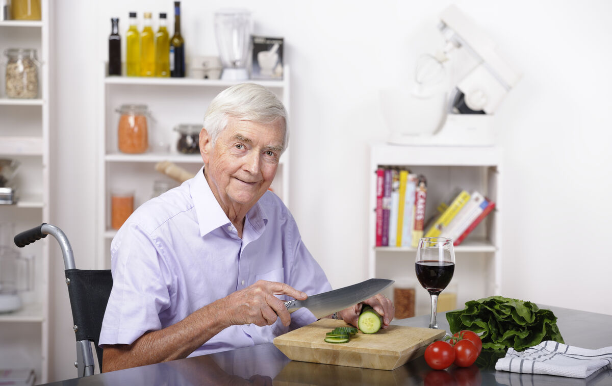 senior man preparing salad