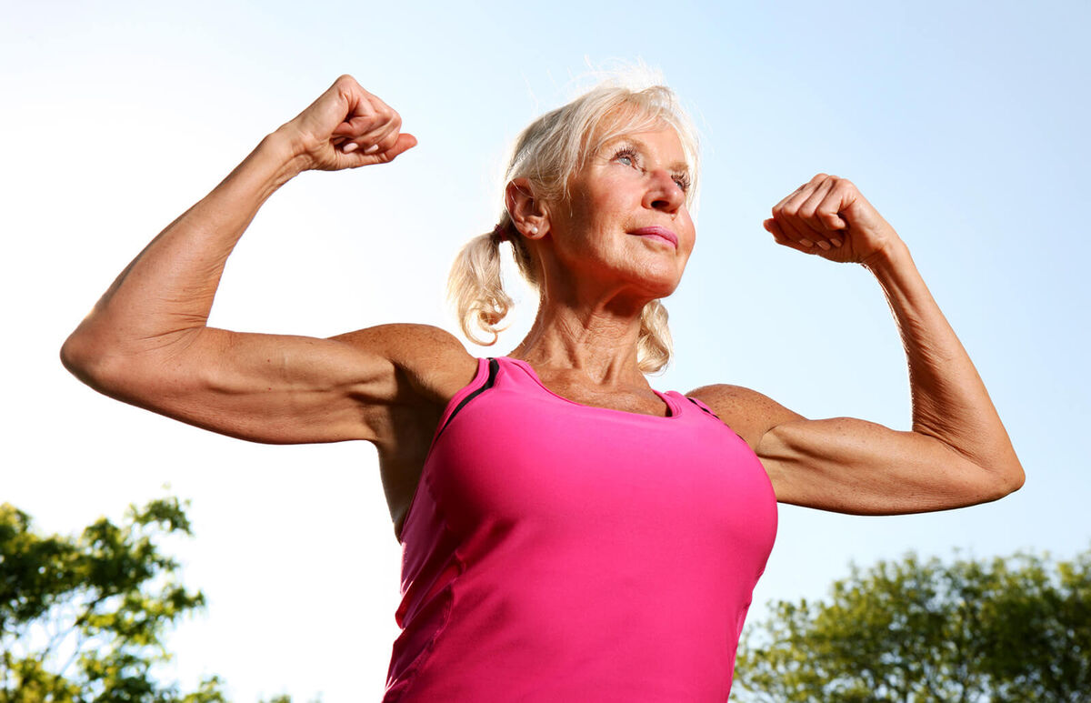 Older woman flexes muscles