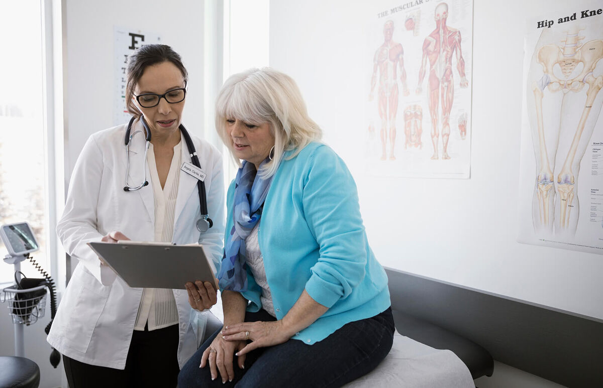 Doctor and senior patient reviewing medical chart