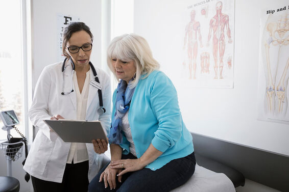 Doctor and senior patient reviewing medical chart