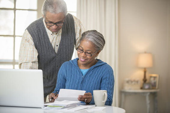 senior couple paying bills