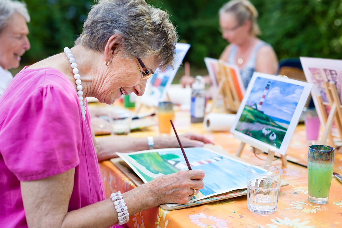 Senior woman drawing largest assisted living companies