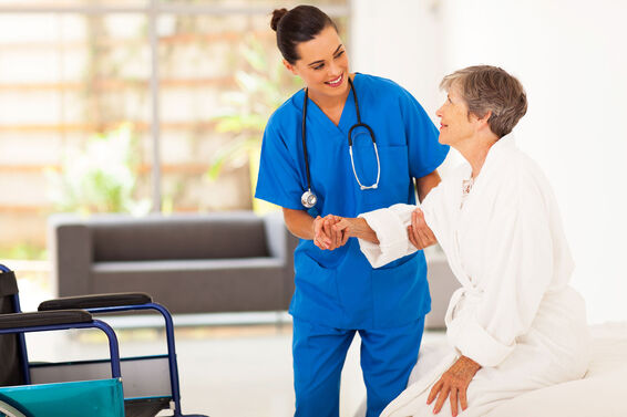 Nurse Helping Senior Woman into wheelchair