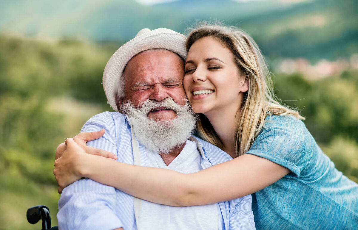 Woman hugging senior man