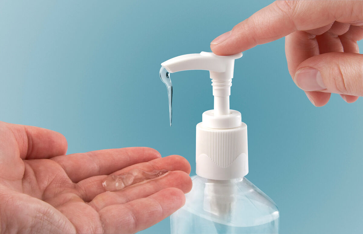 Pumping hand sanitizer into hand