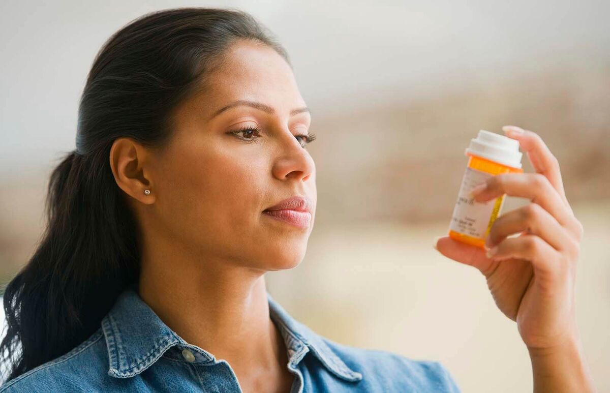 woman reading medication