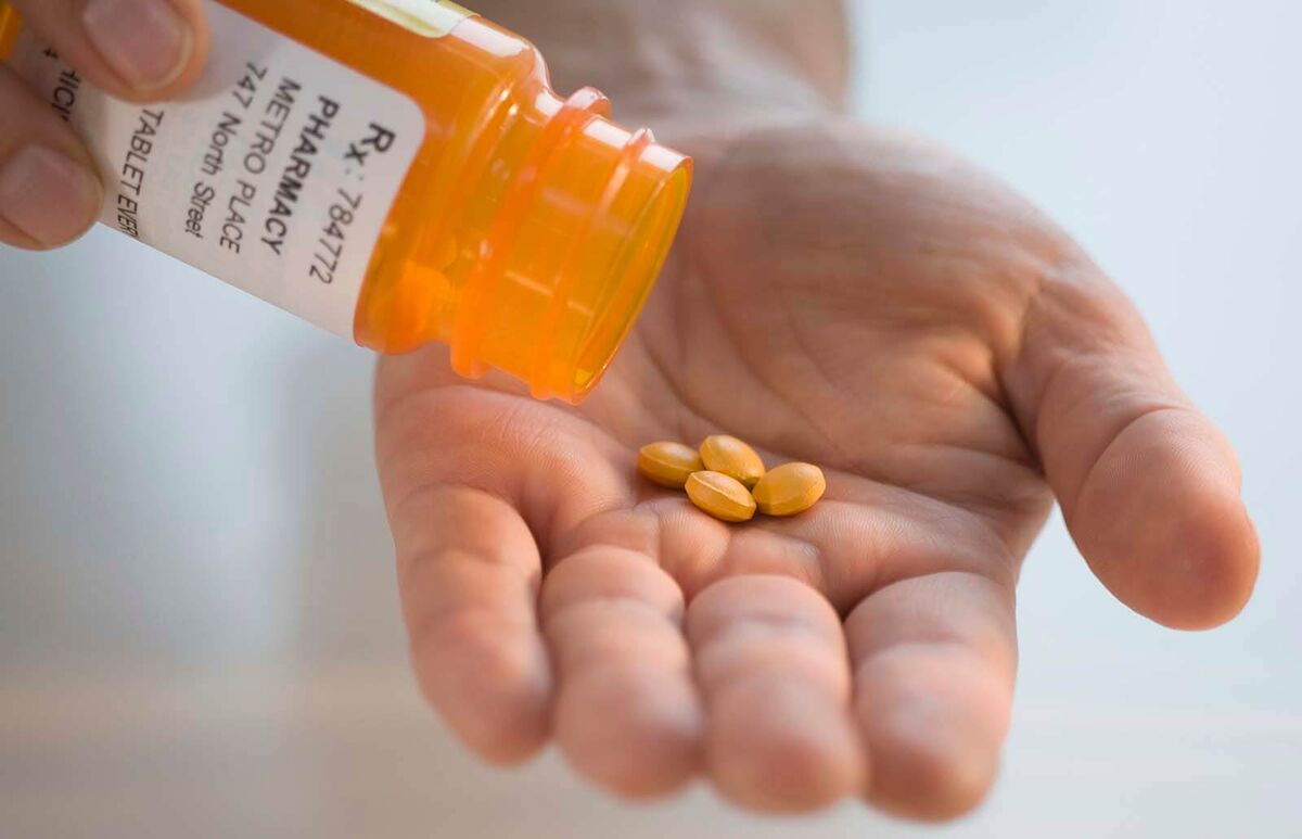 pouring prescription medication into hand