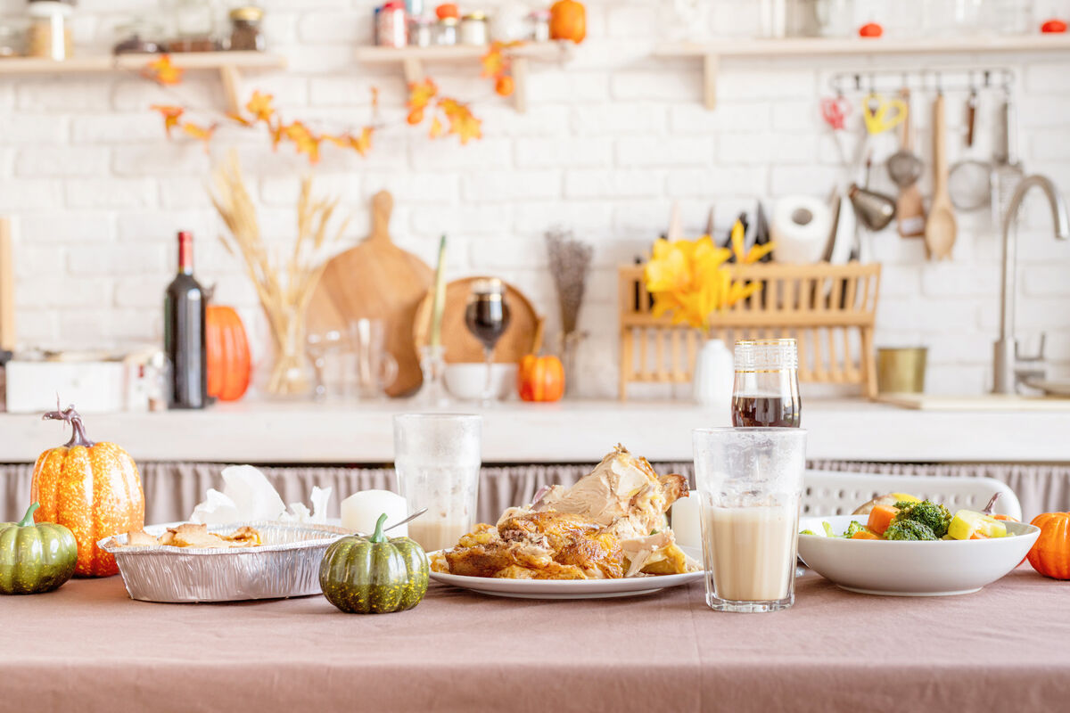 Thanksgiving table after feast with leftovers and dirty dishes